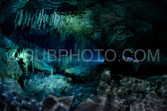 cave diver instructor leading a group of divers in a mexican cenote underwater