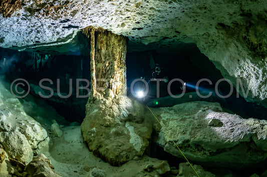 cave diver instructor leading a group of divers in a mexican cenote underwater