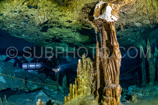 cave diver instructor leading a group of divers in a mexican cenote underwater