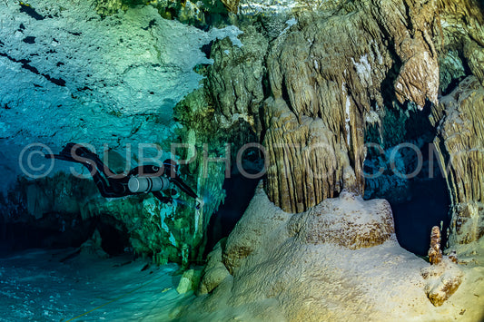 cave diver instructor leading a group of divers in a mexican cenote underwater