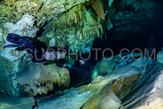 cave diver instructor leading a group of divers in a mexican cenote underwater