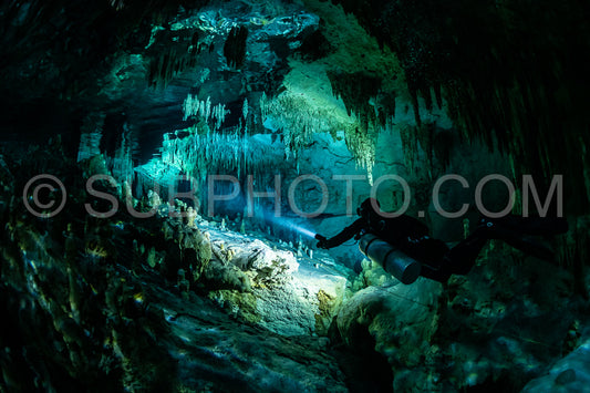 cave diver instructor leading a group of divers in a mexican cenote underwater