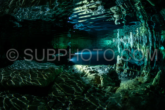 cave diver instructor leading a group of divers in a mexican cenote underwater