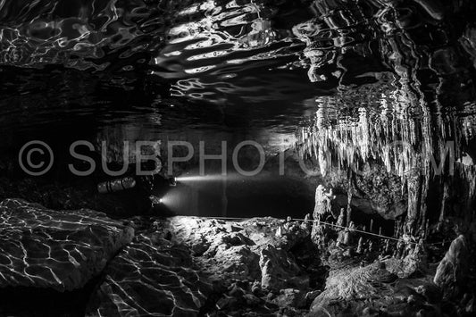 cave diver instructor leading a group of divers in a mexican cenote underwater