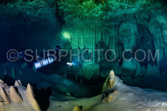cave diver instructor leading a group of divers in a mexican cenote underwater