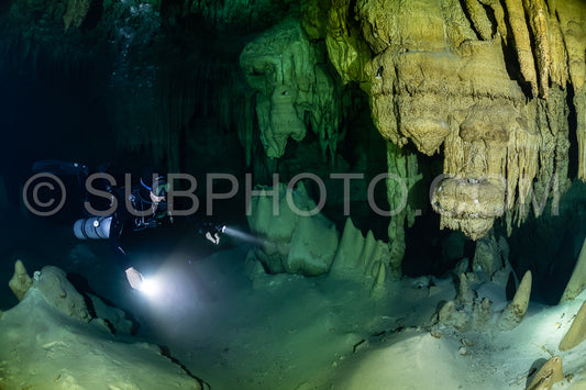 cave diver instructor leading a group of divers in a mexican cenote underwater
