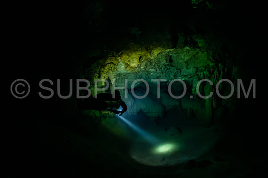 cave diver instructor leading a group of divers in a mexican cenote underwater