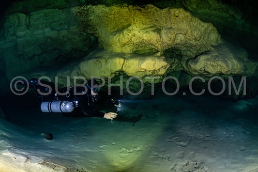 cave diver instructor leading a group of divers in a mexican cenote underwater