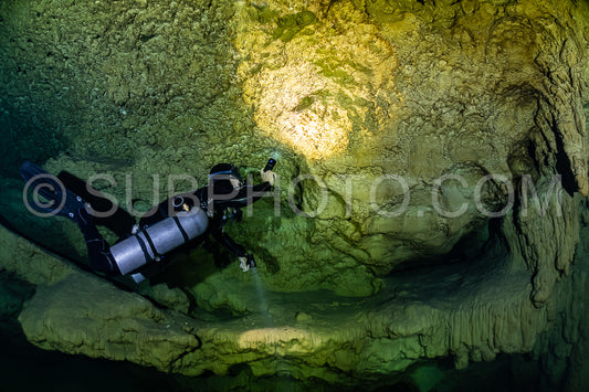 cave diver instructor leading a group of divers in a mexican cenote underwater