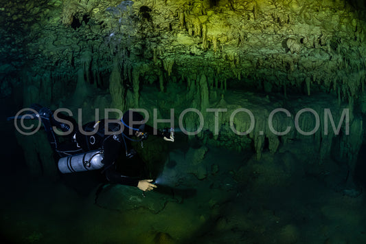 cave diver instructor leading a group of divers in a mexican cenote underwater