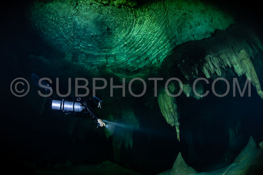 cave diver instructor leading a group of divers in a mexican cenote underwater