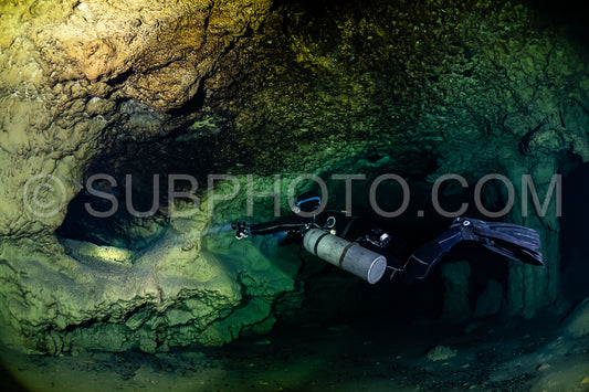 cave diver instructor leading a group of divers in a mexican cenote underwater