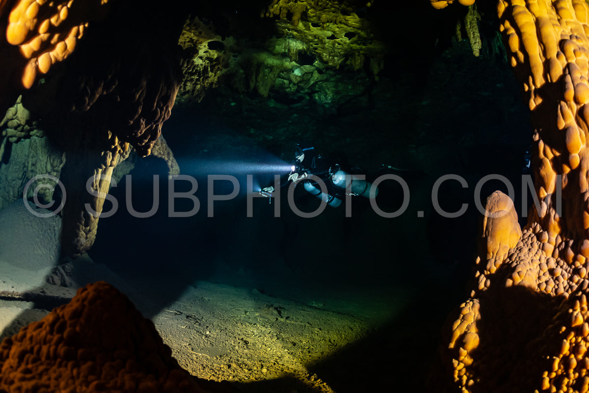 cave diver instructor leading a group of divers in a mexican cenote underwater