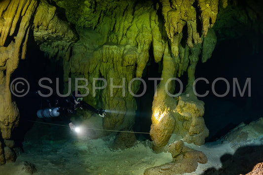 cave diver instructor leading a group of divers in a mexican cenote underwater