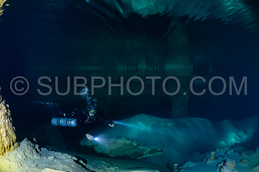 cave diver instructor leading a group of divers in a mexican cenote underwater