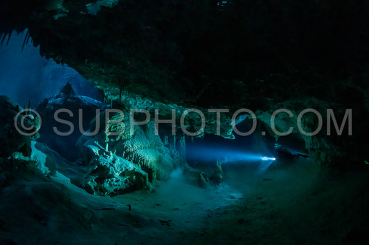 cave diver instructor leading a group of divers in a mexican cenote underwater