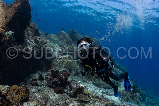 woman diver discovering the beauty of the Komodo National Park caral reef in Indonesia
