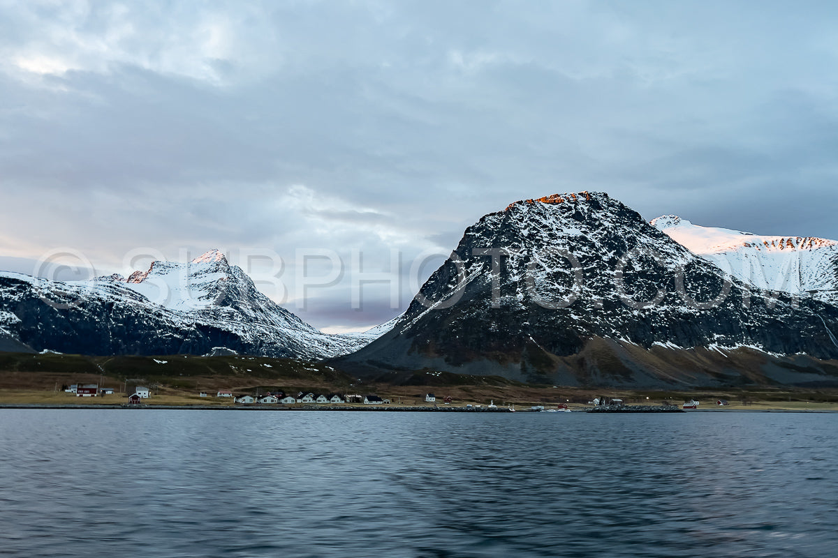 view of KvÃ¦nangen fjord from Seglvik village at dusk