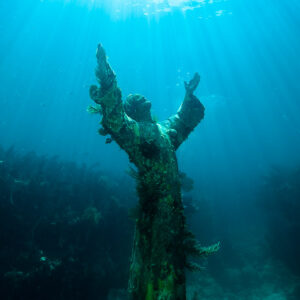 Statue du Christ des Abysses en entier dans l’eau turquoise sous les rayons, Key Largo, Floride, États-Unis