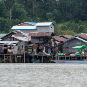 Dense cluster of wooden stilt houses with drying laundry, close view, Maratua, Kalimantan (Borneo), Indonesia