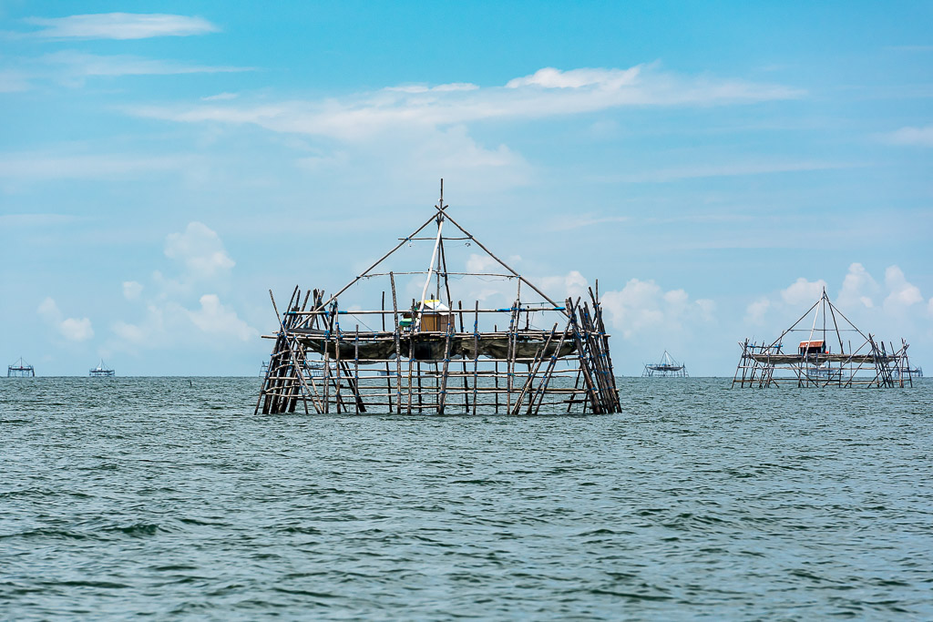 Bamboo bagang fishing platform with another in the distance on calm sea, Maratua, Kalimantan (Borneo), Indonesia