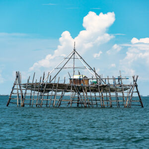 Bagang fishing platform with pyramid frame under towering cumulus clouds, Maratua, Kalimantan (Borneo), Indonesia