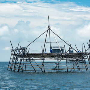 Bamboo bagang fishing platform standing alone in open sea under white clouds, Maratua, Kalimantan (Borneo), Indonesia
