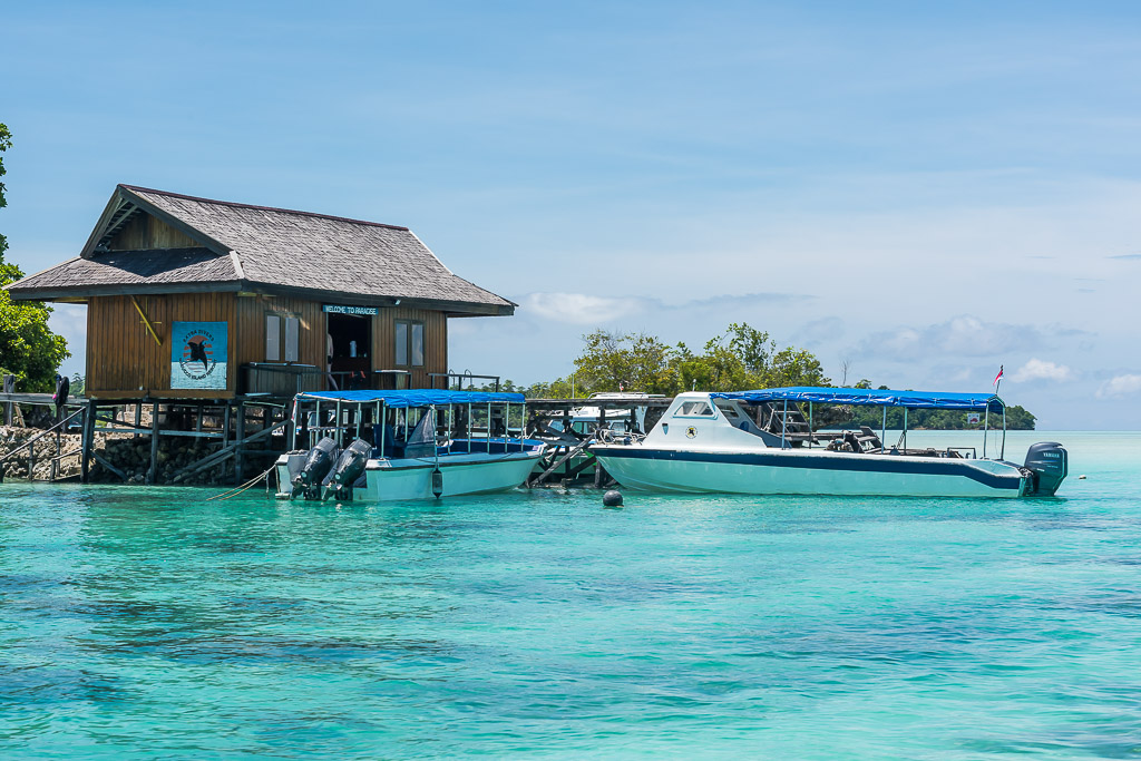 Dive centre jetty building with two dive boats moored on turquoise water, Maratua, Kalimantan (Borneo), Indonesia