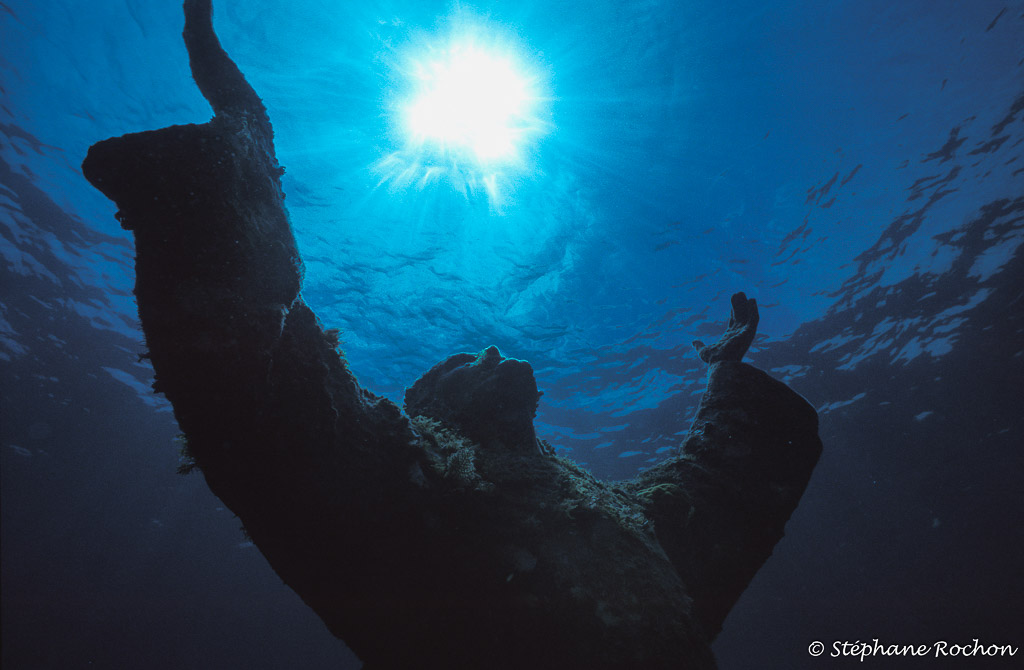 Christ of the Abyss silhouette against the sun, watermarked version, Key Largo, Florida, USA