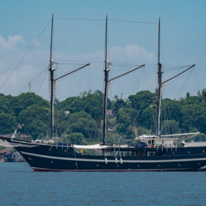 Black-hulled three-masted wooden schooner at anchor, Misool, Raja Ampat, Indonesia