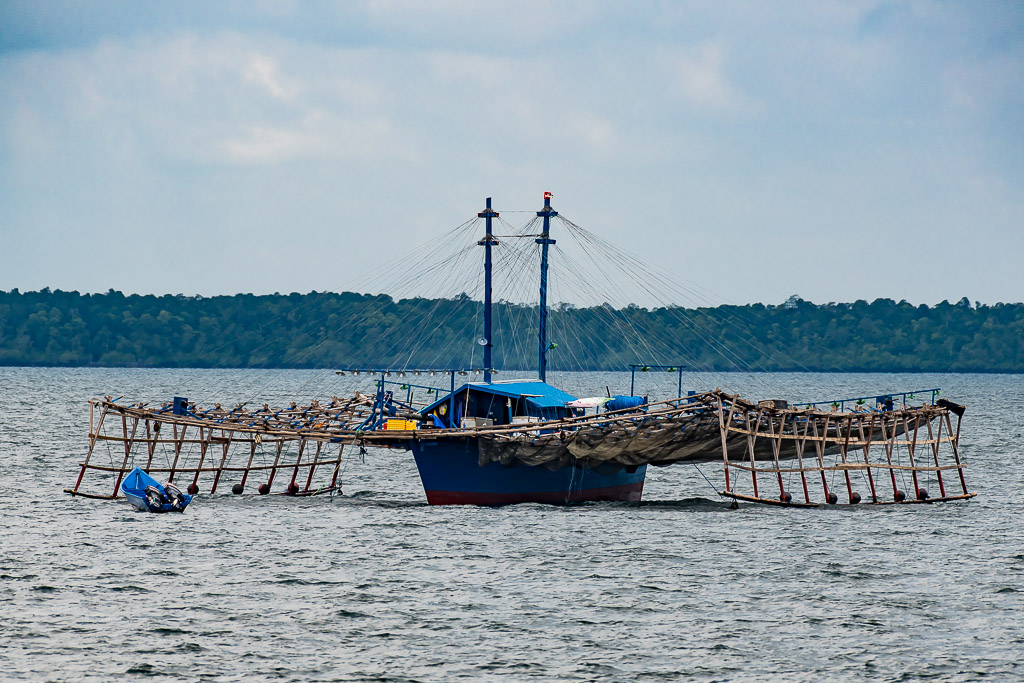 Traditional bagan lift-net fishing boat with wooden outrigger frames, Misool, Raja Ampat, Indonesia