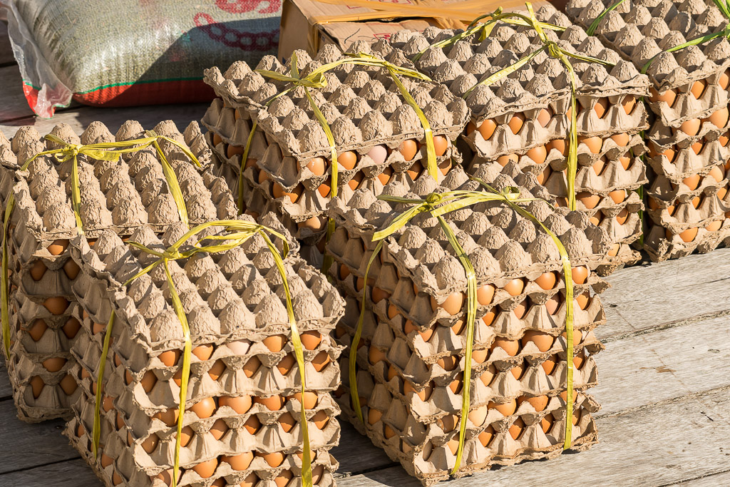 Stacks of egg trays tied with string on a wooden jetty, Misool, Raja Ampat, Indonesia