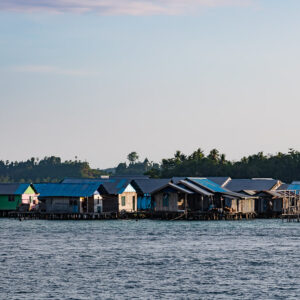 Colourful houses on stilts over the water, telephoto view, Misool, Raja Ampat, Indonesia