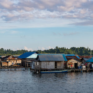 Large tin-roofed stilt house centred in a waterfront row, Misool, Raja Ampat, Indonesia