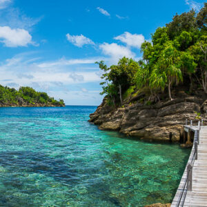 Panoramic boardwalk to a white beach over turquoise water, Misool, Raja Ampat, Indonesia