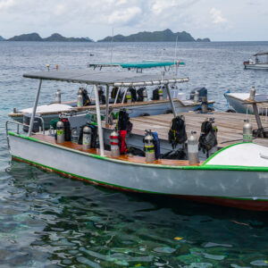 Dive boat loaded with tanks and gear moored at a jetty, Misool, Raja Ampat, Indonesia