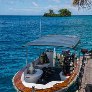 Dive boat with gear seen from above at a jetty, vertical, Misool, Raja Ampat, Indonesia
