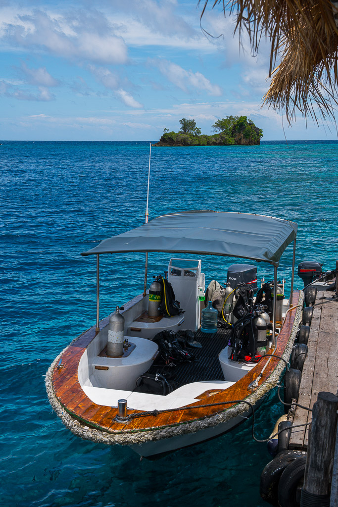 Dive boat with gear seen from above at a jetty, vertical, Misool, Raja Ampat, Indonesia
