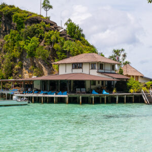 Main resort building on stilts in front of a limestone cliff, Misool, Raja Ampat, Indonesia