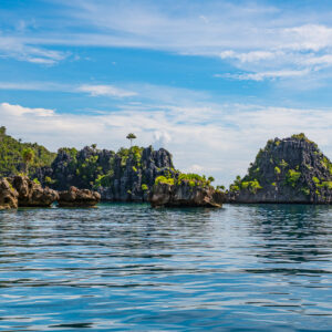 Group of jagged karst islets over a calm sea, Misool, Raja Ampat, Indonesia