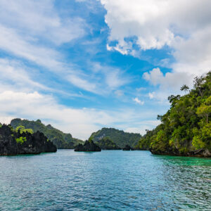 Wide-angle karst channel with a forested slope on the right, Misool, Raja Ampat, Indonesia
