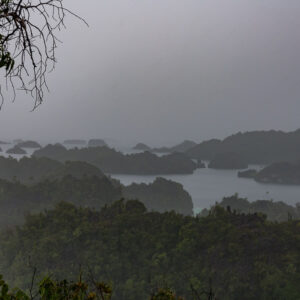 Karst islands and lagoons veiled by heavy rain from a viewpoint, Misool, Raja Ampat, Indonesia