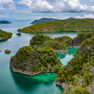 Karst islets and a large green island beyond the lagoon, Waigeo, Raja Ampat, Indonesia