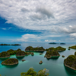 Islet-filled lagoon under dramatic clouds, wide view, Waigeo, Raja Ampat, Indonesia