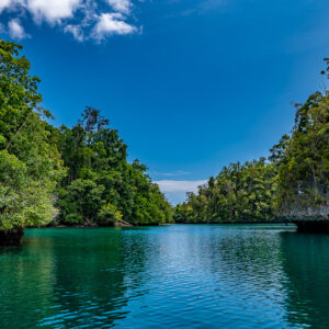 Emerald channel between forested islets with clouds, wider view, Waigeo, Raja Ampat, Indonesia