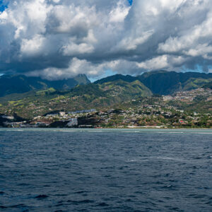 Mountainous coastline with a hillside town under billowing clouds, Tahiti, Society Islands, French Polynesia