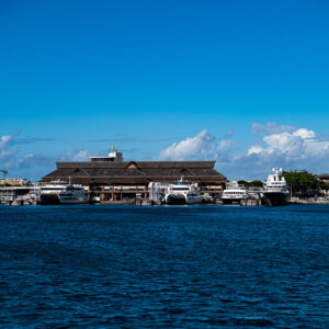 Port building with a large wooden roof and moored boats seen from the sea, Tahiti, Society Islands, French Polynesia