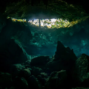 Daylight opening seen from inside a dark cenote cavern, no diver, Quintana Roo, Mexico
