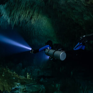Sidemount diver close to the camera under a stalactite fringe, Quintana Roo, Mexico