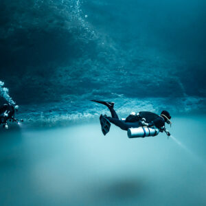 Two sidemount divers hovering over the sulfide cloud, wide view, Cenote Angelita, Quintana Roo, Mexico